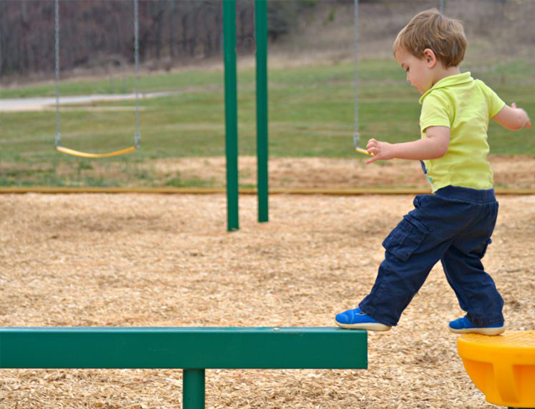 child on playground balance