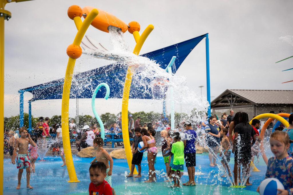 large splash pad water element dunking water on children