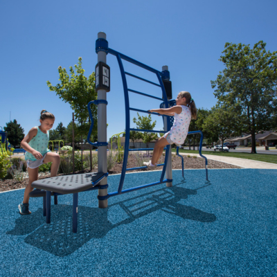 two young girls using platform and ladder elements on outdoor fitness equipment