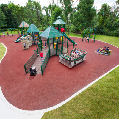 large inclusive playground installed on safety surfacing