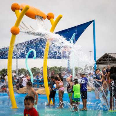 large splash pad water element dunking water on children