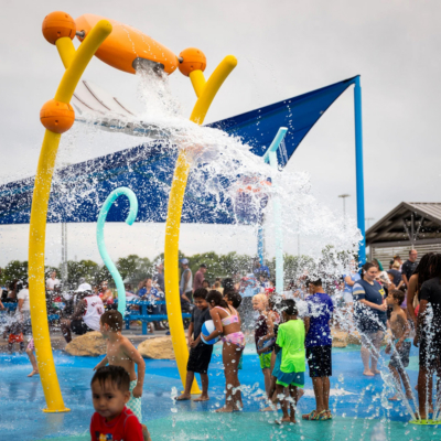 large splash pad water element dunking water on children