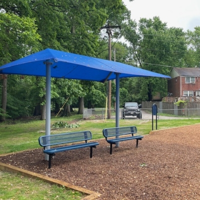 blue shade structure covering two blue benches