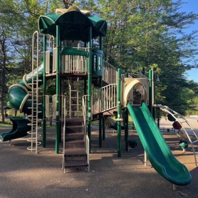 tall playground structure that has two slides and multiple climbing ladders