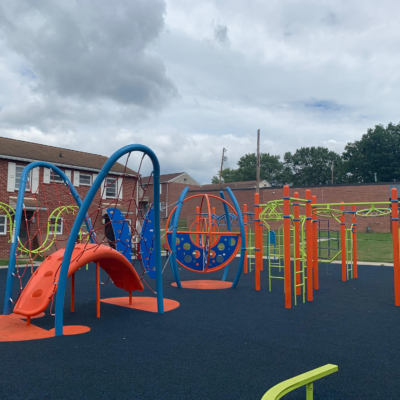 large play structure that is blue, orange, and lime green