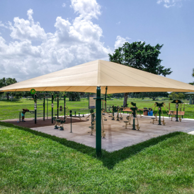 large shade structure covering outdoor fitness equipment
